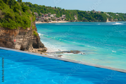 Swimming pool with a view of the sea from a cliff. Dreamland Beach, Bukit Peninsula, Bali, Indonesia.