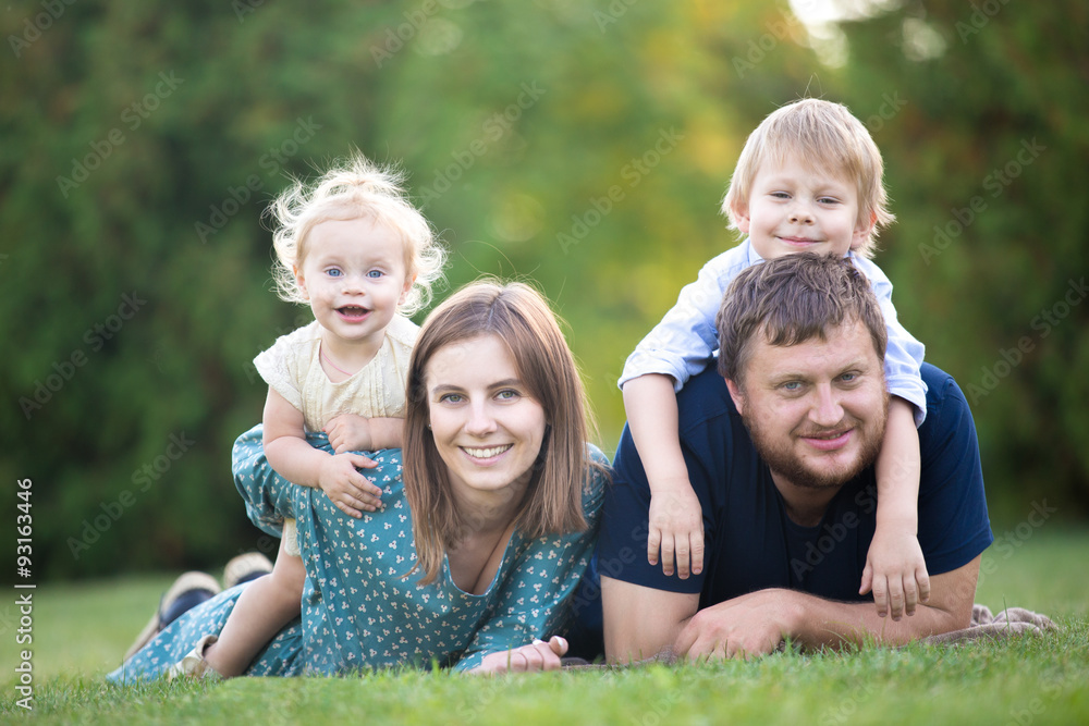Fototapeta premium Couple with two kids in park
