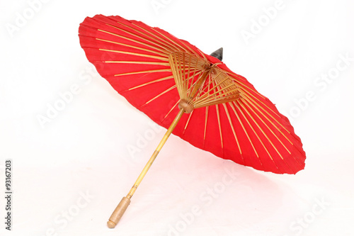 A handmade red  Asian parasol or umbrella isolated