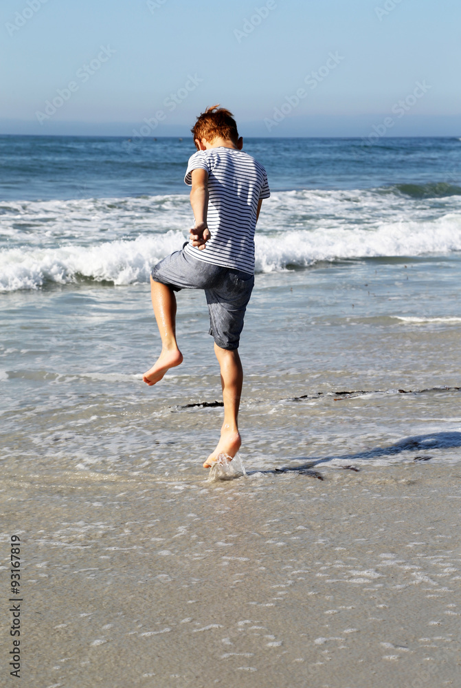 boy jumping on the beach