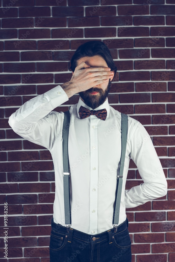 A bearded Man covering eyes A bearded Man covering eyes