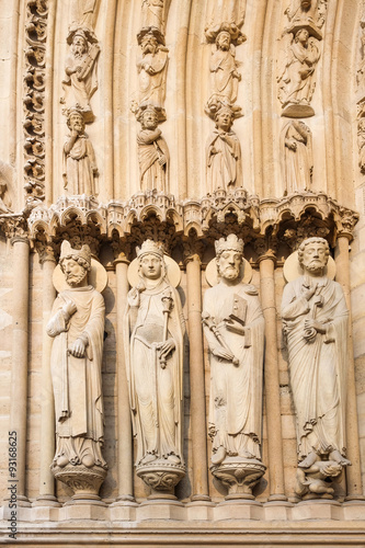 .Paris, France - famous Notre Dame cathedral facade saint statue