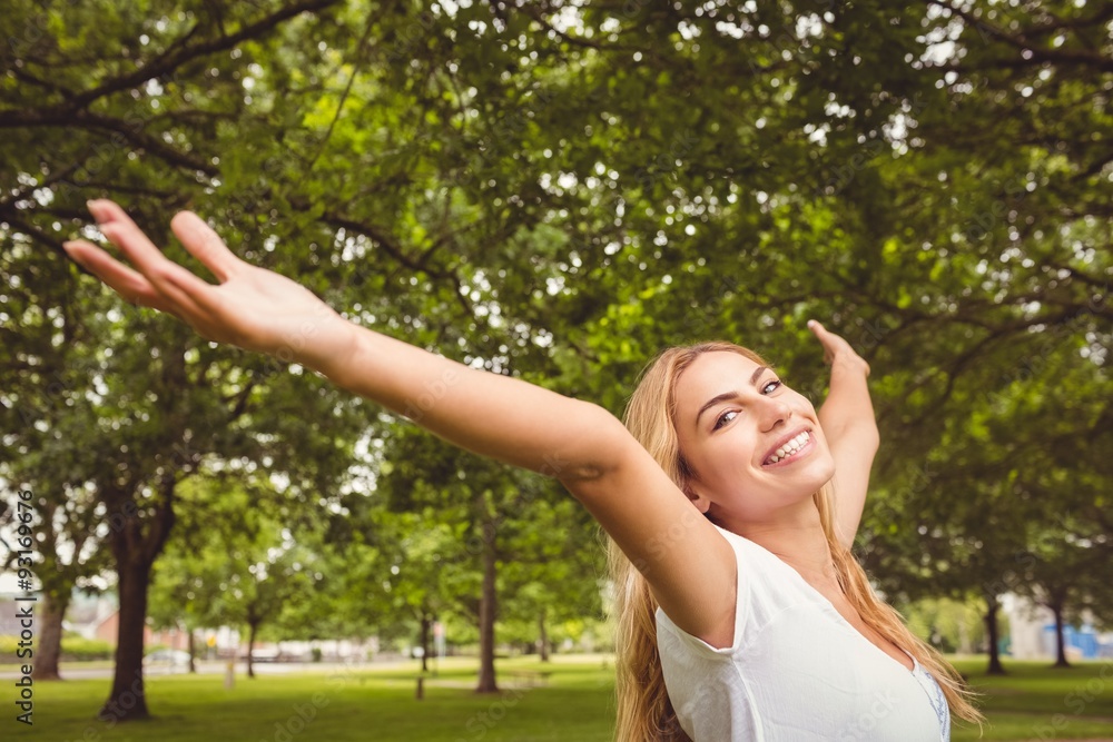 Portrait of smiling woman with arms raised in park Portrait of smiling woman with arms raised in park