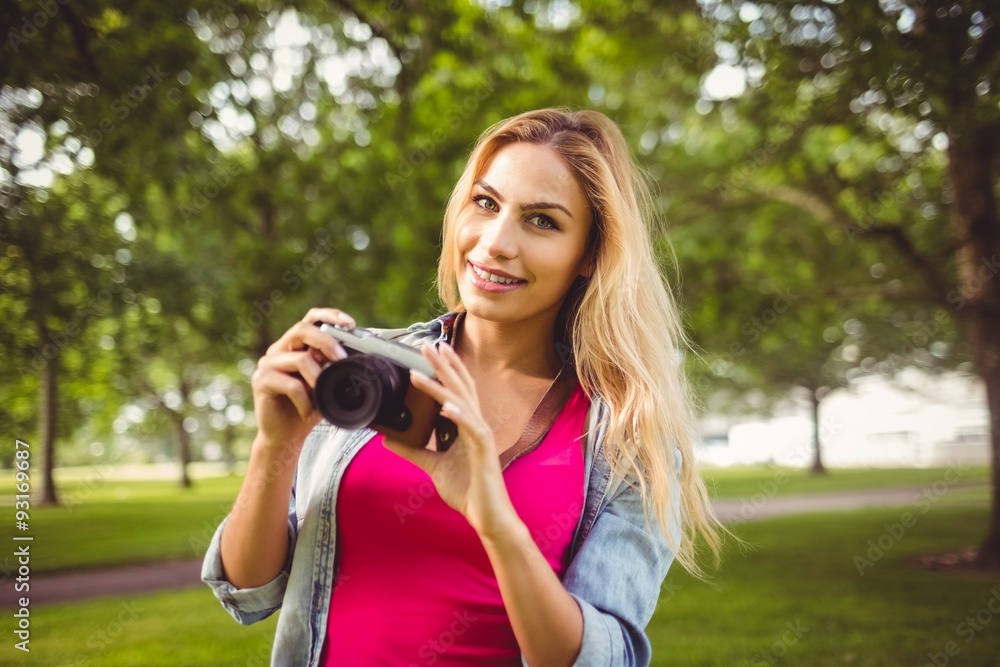 Smiling woman holding camera 