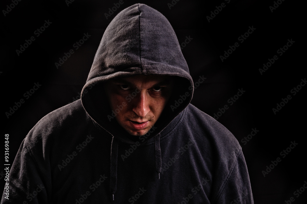 man with hoodie or hooligan over dark background man with hoodie or hooligan over dark background