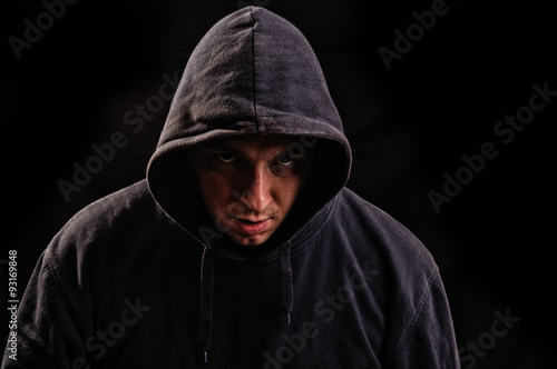 man with hoodie or hooligan over dark background