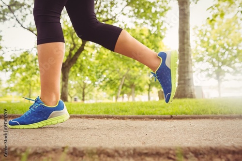 Woman wearing sport shoes jogging in park