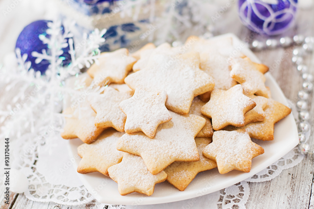 Christmas cookies and tinsel on a light wooden background Christmas cookies and tinsel on a light wooden background