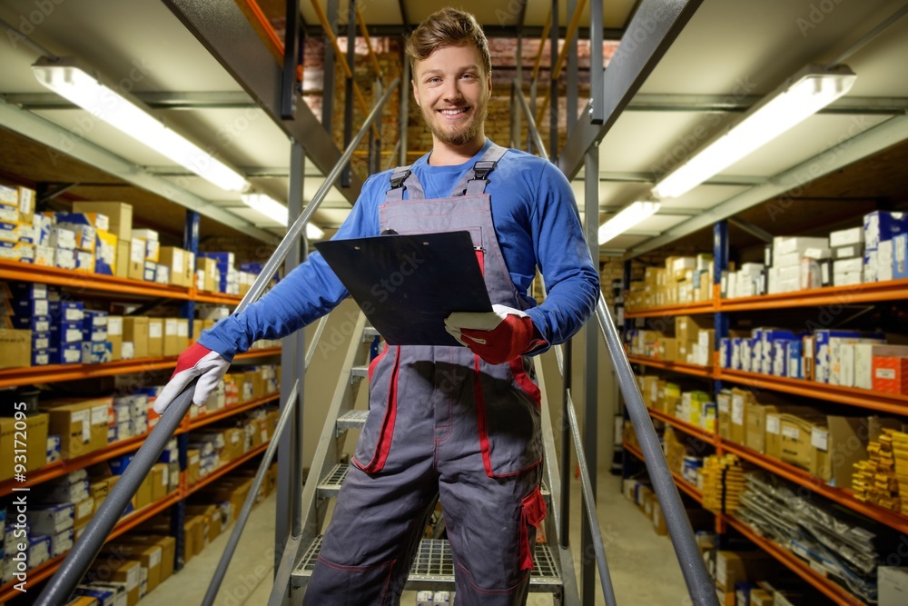 Worker on a automotive spare parts warehouse Worker on a automotive spare parts warehouse