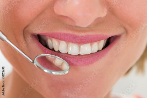 Woman With Teeth And Dentist Mirror