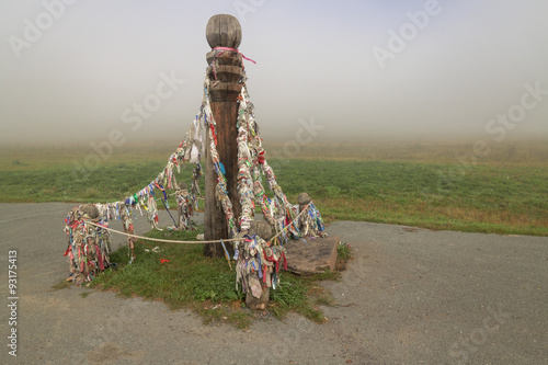 Ceremonial pole with ribbons on the road photo