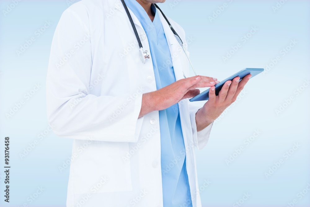 Composite image of male doctor using tablet Composite image of male doctor using tablet