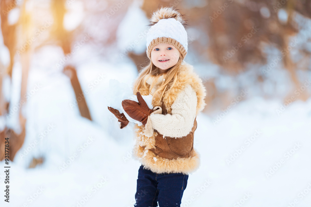 Little girl enjoying a day out playing in the winter forest Little girl enjoying a day out playing in the winter forest