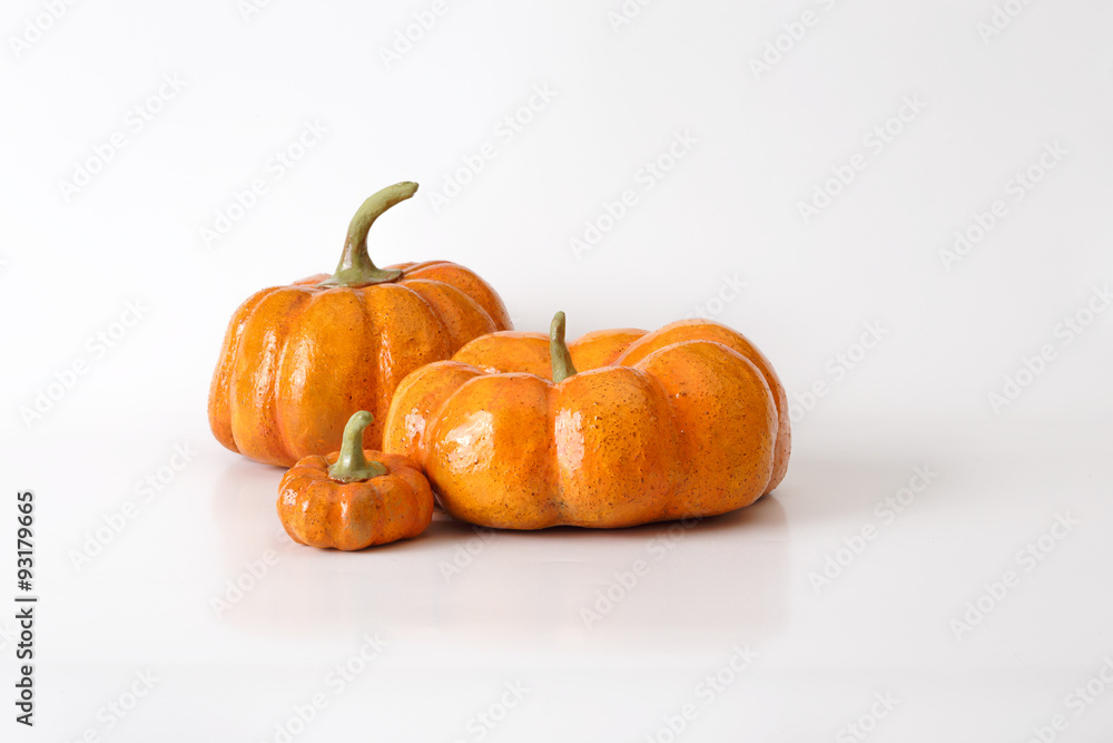 Fototapeta premium Three orange halloween pumpkin gift on white background