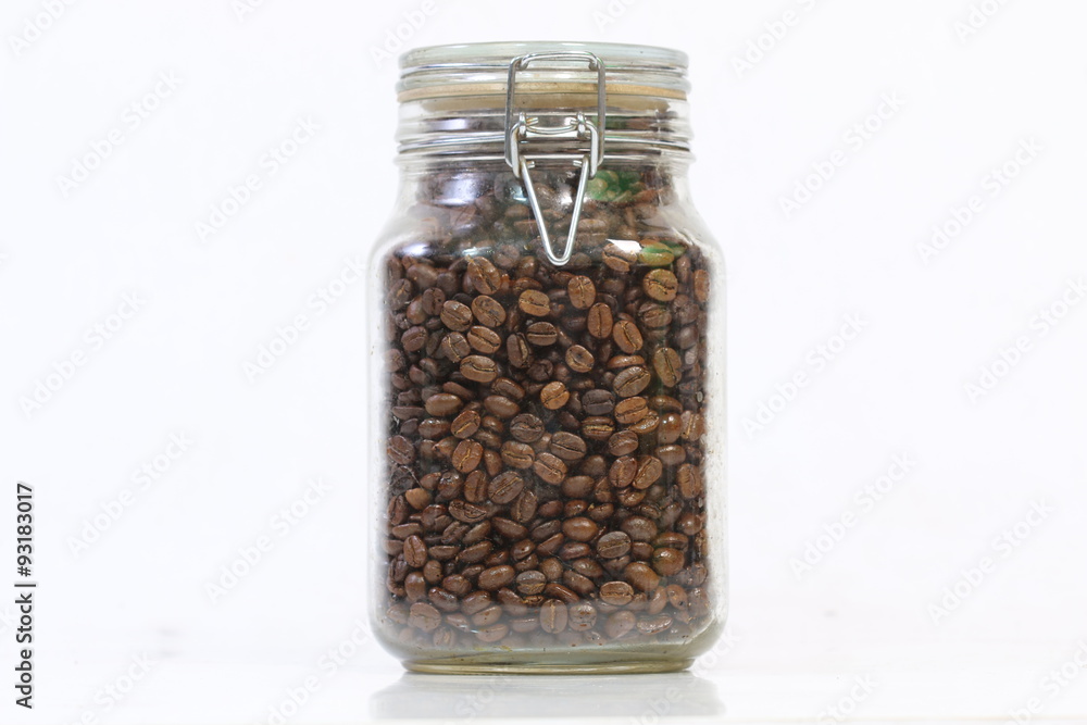 jar glass with coffee beans inside on white background jar glass with coffee beans inside on white background