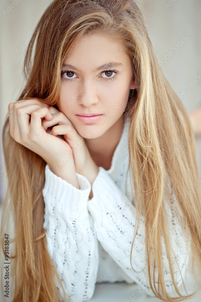 Young girl are posing in sweater at home Young girl are posing in sweater at home