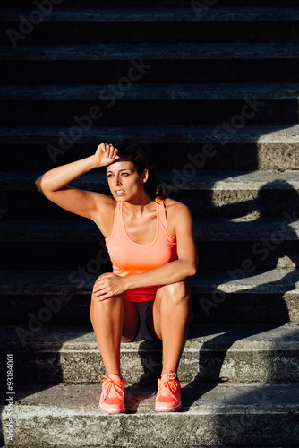 Sweaty sporty woman taking a fitness workout rest.  Motivation and healthy lifestyle concept.