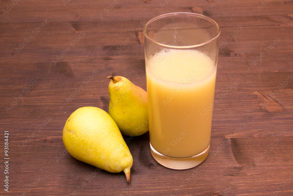 Glass with pear juice on wooden table Glass with pear juice on wooden table