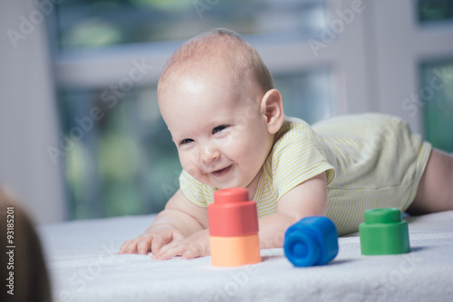 Cute little child is playing with toys