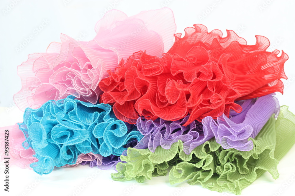 Small, colorful fabric chifong pressing on a white background. Small, colorful fabric chifong pressing on a white background.