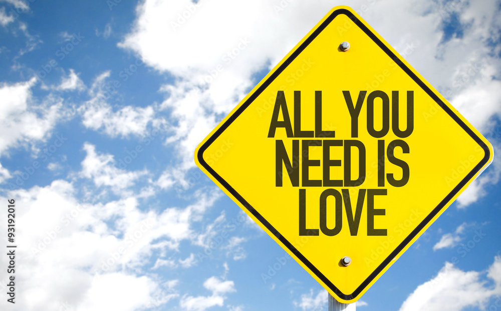 All You Need is Love sign with sky background