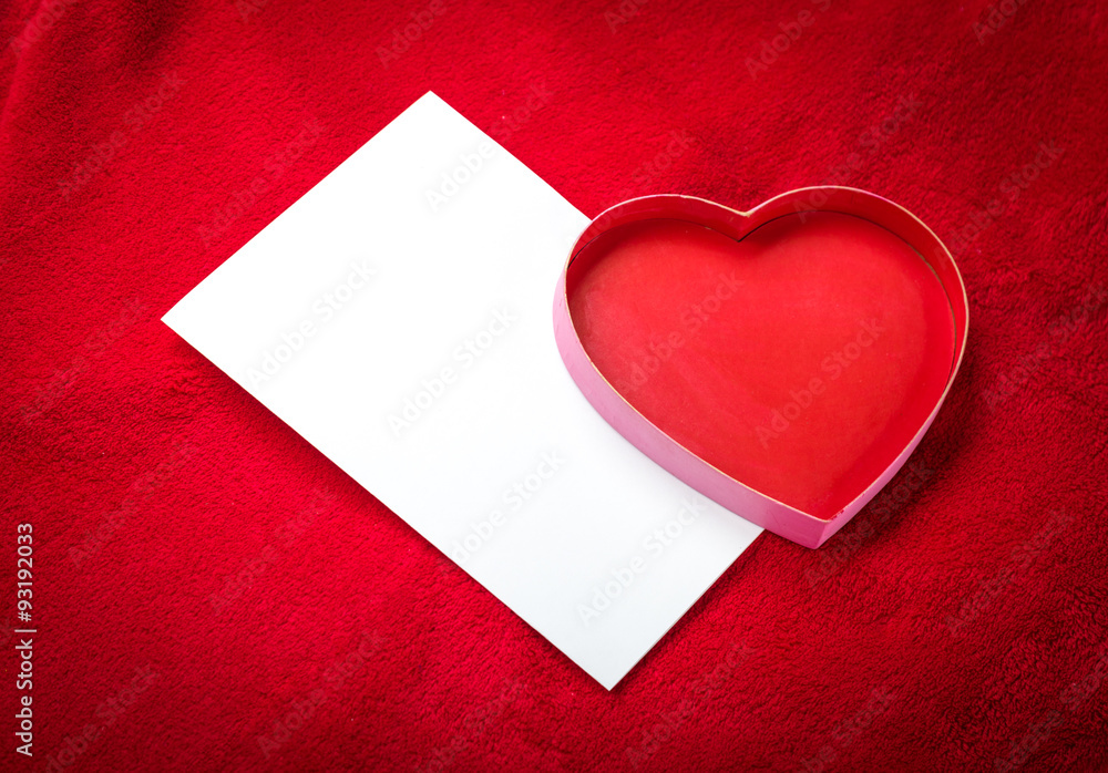 heart with a blank card on red background heart with a blank card on red background