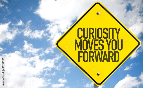 Curiosity Moves You Forward sign with sky background photo