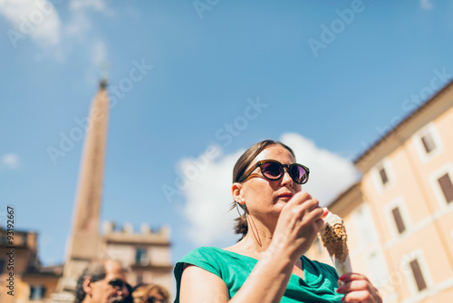 Female tourist eating icecream in Rome, Italy. © ysbrandcosijn