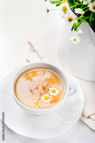 Camomile hebal tea in a white cup with photo