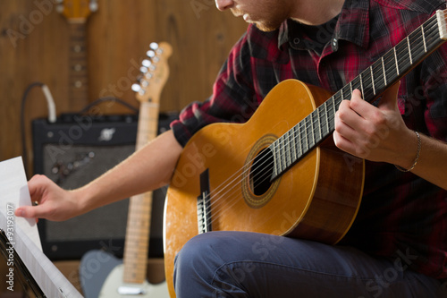 Young man playing acoustic guitar.