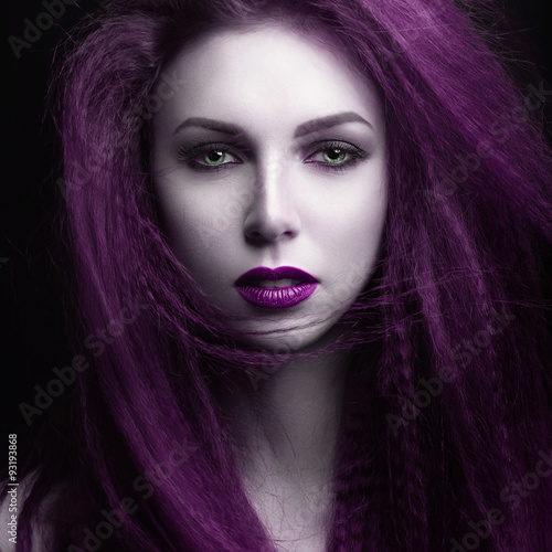 The girl with pale skin and purple hair in the form of a vampire