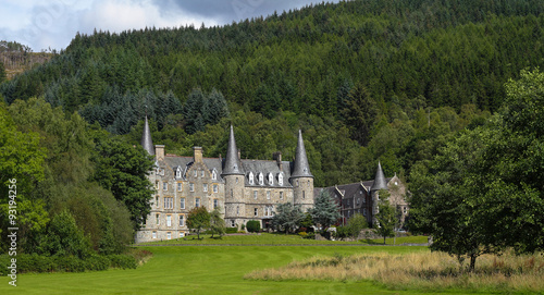 Tigh Mor nestled in green wooded hills, The Trossachs, Scotland photo
