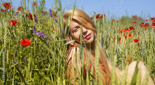 Girl in field with flower of the poppy. Девушка в поле с цветком мака  