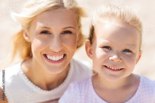 happy mother and little daughter on summer beach