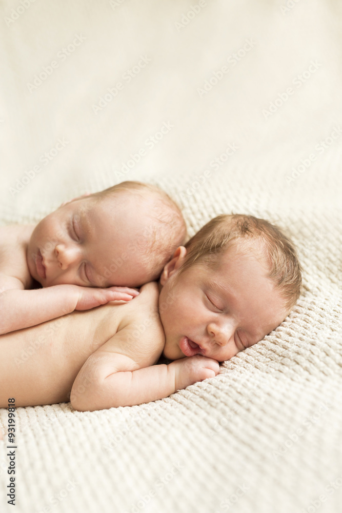 Newborn twins sleeping on blanket Newborn twins sleeping on blanket