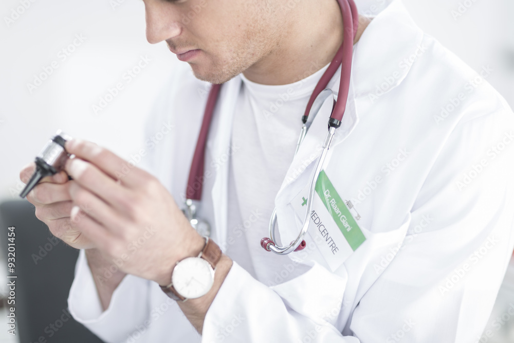 Close-up of doctor with otoscope Close-up of doctor with otoscope