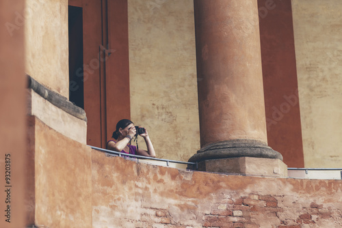 Female tourist taking pictures of architecture at San Luca in Bo