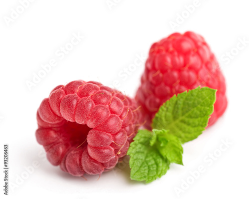 fresh ripe raspberries with mint leaves isolated on white