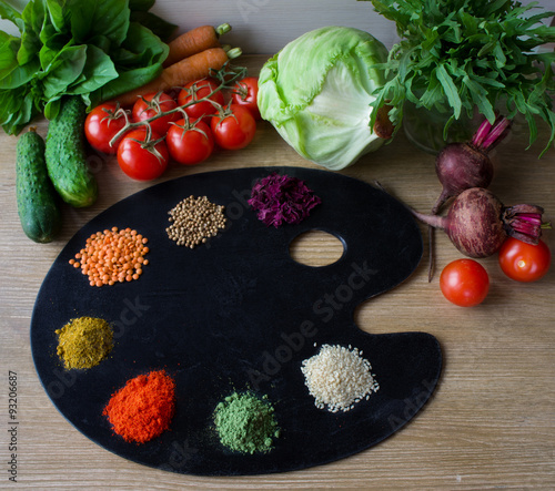 Painting palette with various spices and herbs, on color wooden