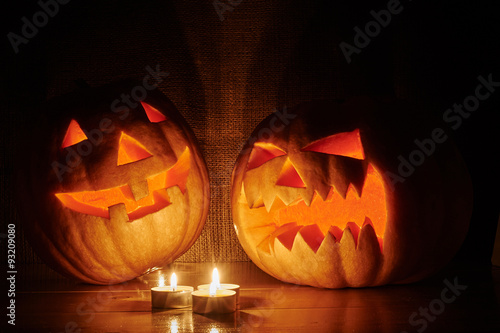 Halloween orange pumpkins jack lantern with candles on a wooden