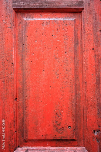 red painted wooden door detail texture background © qphotomania