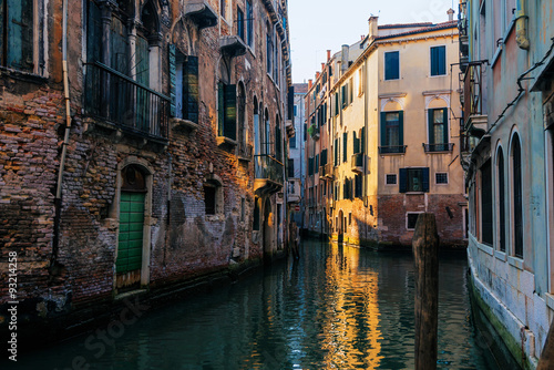 Narrow canal among old  houses, Venice, Italy. © sola_sola