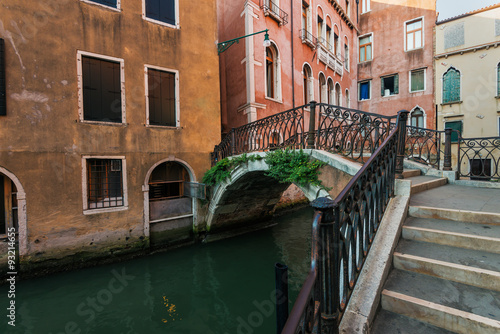 Narrow canal among old houses, Venice, Italy.