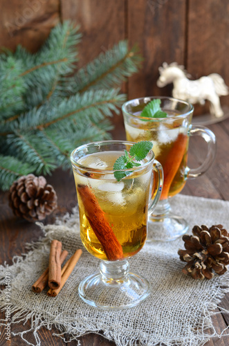 Whiskey cocktail with cinnamon on Christmas background 