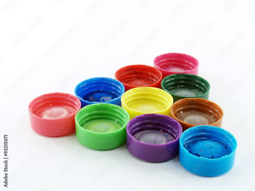 close-up group of colorful plastic bottle lids of poster color arrange to triangle formed isolated on white background, learning shapes for children close-up group of colorful plastic bottle lids of poster color arrange to triangle formed isolated on white background, learning shapes for children