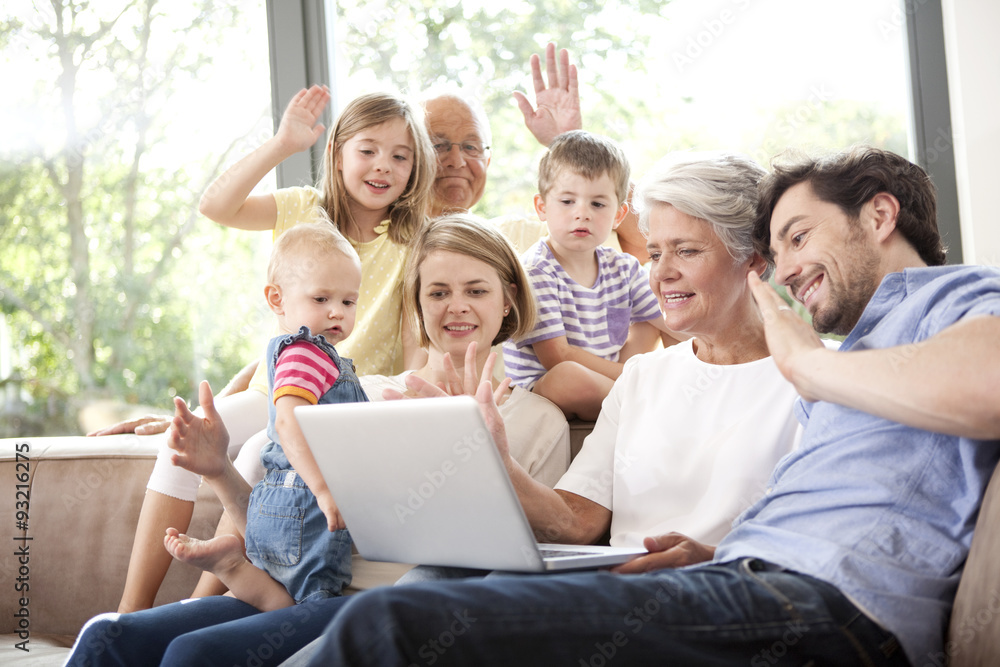 Extended family on couch having a videoconference Extended family on couch having a videoconference