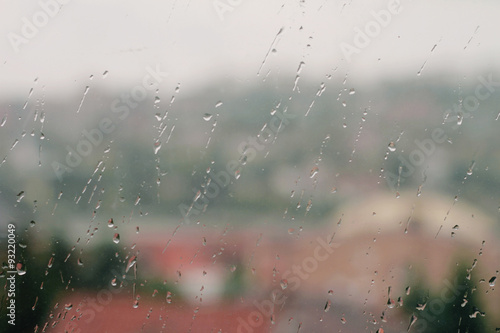 Raindrops on window glass. Autumn background
