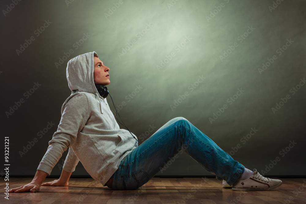Hooded man with headphones on neck Hooded man with headphones on neck