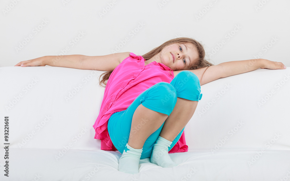 Tired exhausted lazy little girl kid lying on sofa
