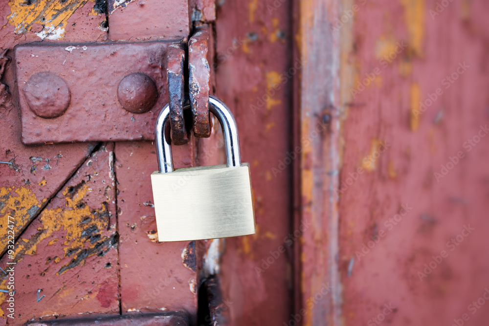 new padlock on an old red wooden gate new padlock on an old red wooden gate